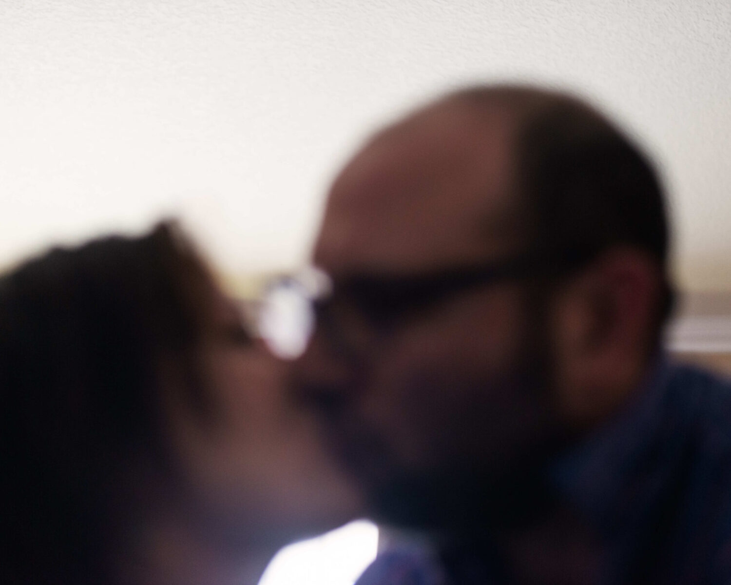 17. jordan and anna kissing, the photo jesse wanted to takA 20 Minutes or Less—Teaching Jesse Photography. When asked what he wanted to capture, he chose a kiss between his parents. (Photo by Jesse Rathkopf, January 20, 2022)